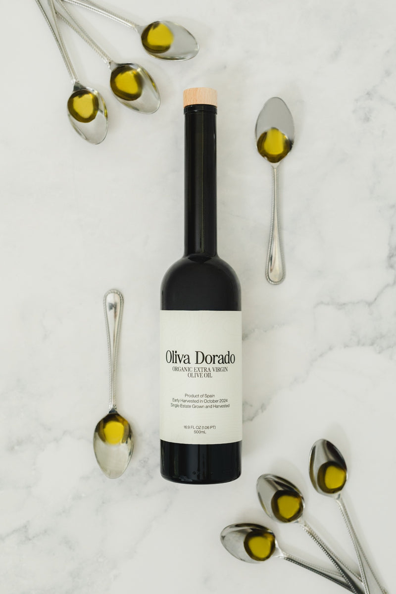 A 500mL bottle of Oliva Dorado olive oil with tasting spoons