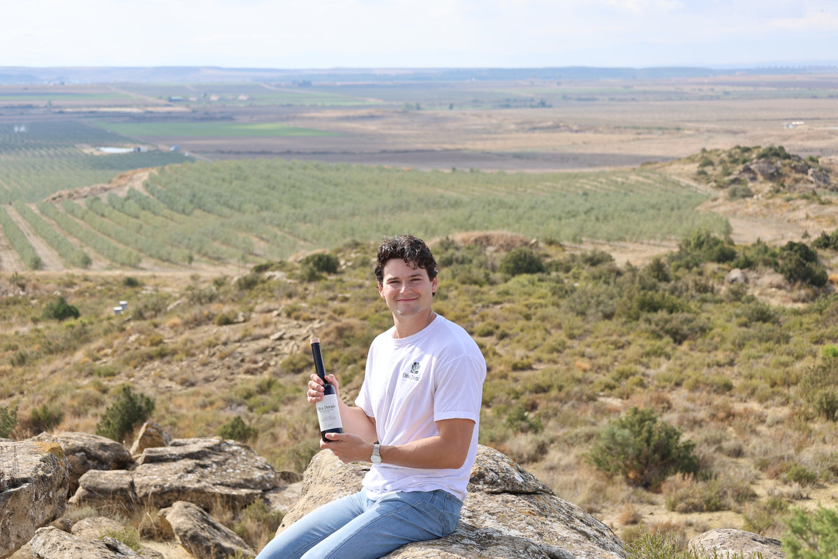 Jeremy with a bottle of Oliva Dorado above the family farm's olive groves in Zaragoza